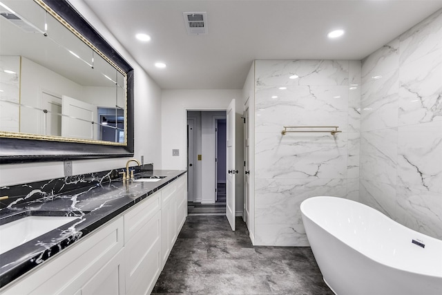 bathroom with vanity, a bath, and concrete flooring