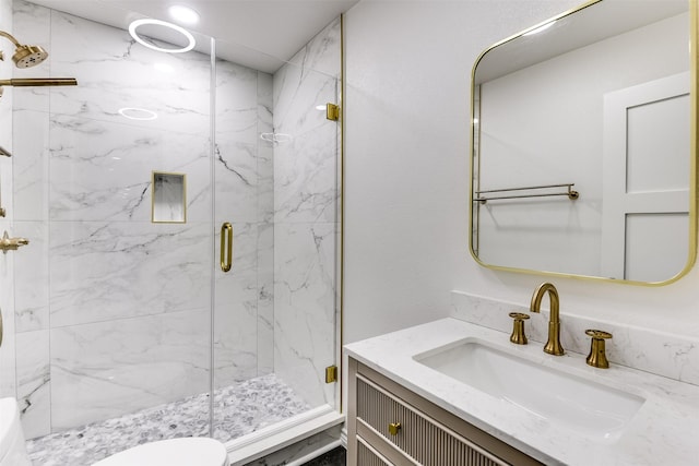 bathroom featuring vanity and a shower with door