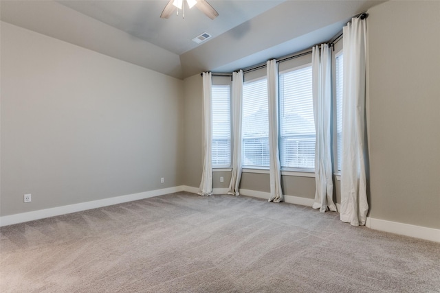 carpeted empty room with vaulted ceiling and ceiling fan