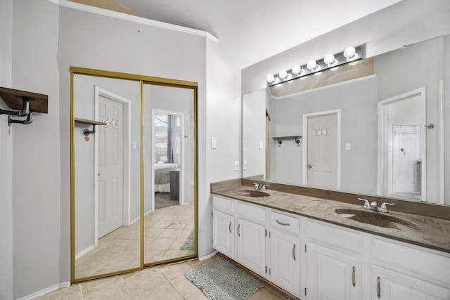 bathroom featuring lofted ceiling, vanity, and tile patterned floors