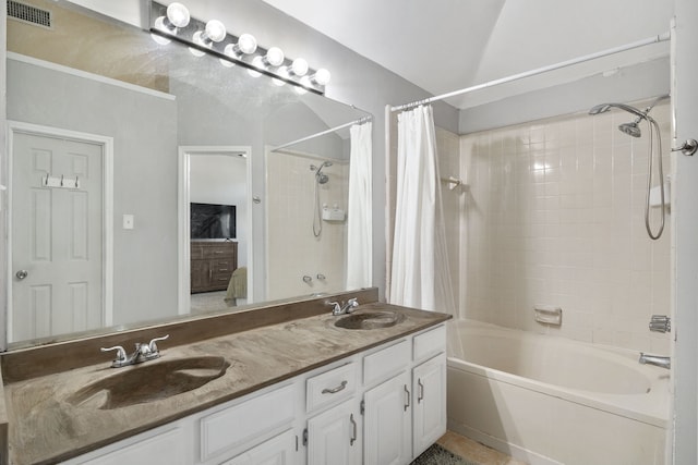 bathroom with shower / tub combo, vanity, and lofted ceiling