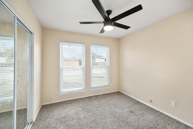 spare room featuring carpet floors and ceiling fan