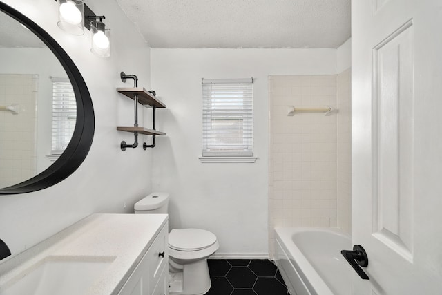 full bathroom with tile patterned floors, vanity, toilet, and a textured ceiling