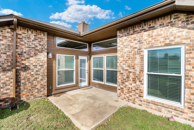 entrance to property featuring a patio