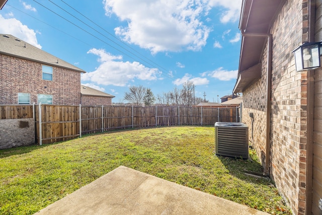 view of yard featuring central AC and a patio