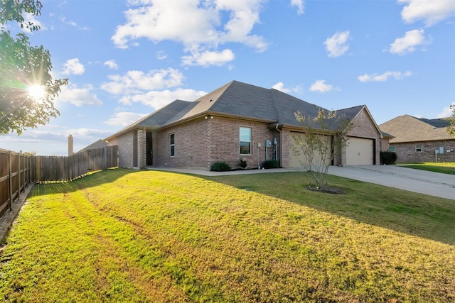 view of front of home with a garage and a front lawn