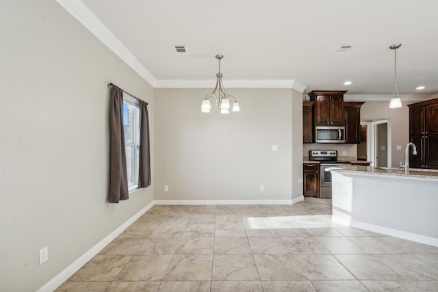 kitchen with hanging light fixtures, appliances with stainless steel finishes, dark brown cabinets, and sink