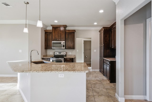 kitchen with sink, stainless steel appliances, dark brown cabinetry, a center island with sink, and decorative light fixtures