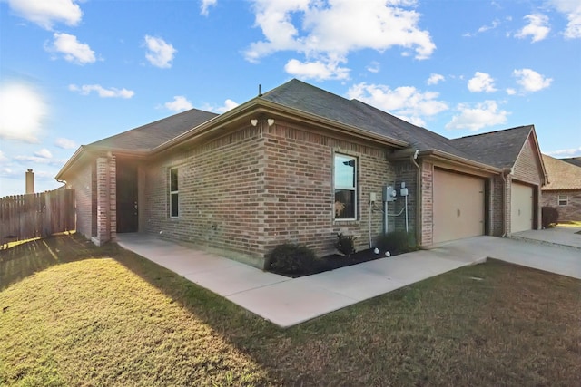 view of home's exterior featuring a garage and a lawn