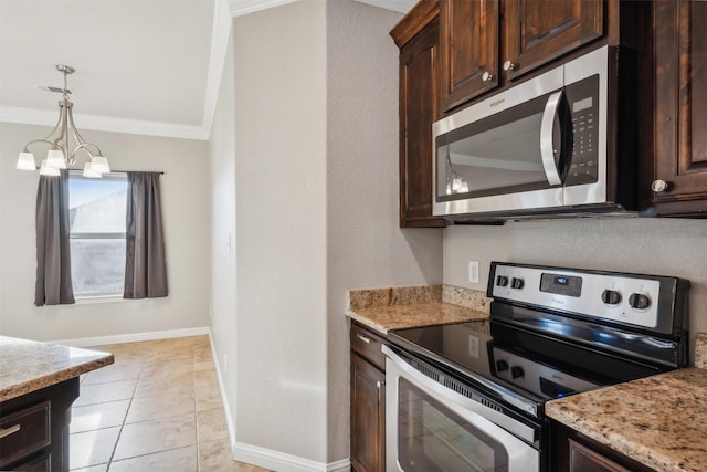 kitchen featuring light stone counters, ornamental molding, stainless steel appliances, and an inviting chandelier