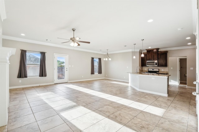 kitchen featuring dark brown cabinetry, light stone counters, ornamental molding, pendant lighting, and stainless steel appliances