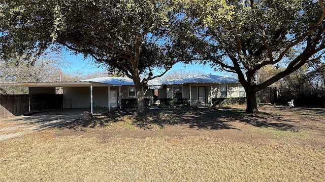 back of property with a carport