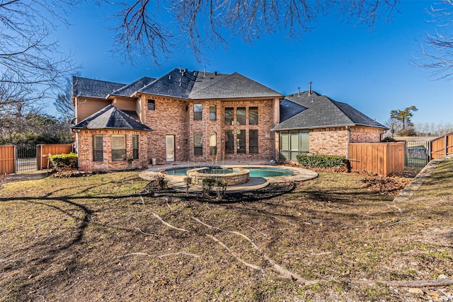 back of house featuring a swimming pool with hot tub and a lawn