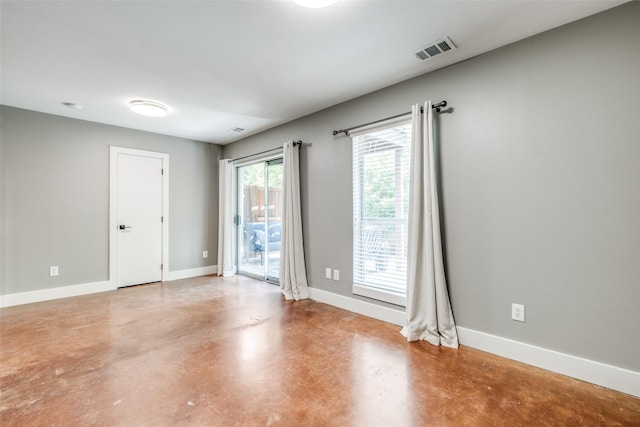 spare room with concrete flooring