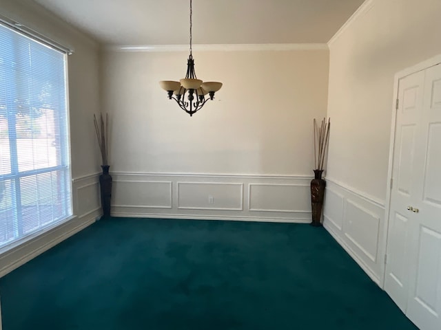 unfurnished dining area featuring an inviting chandelier, crown molding, and dark colored carpet