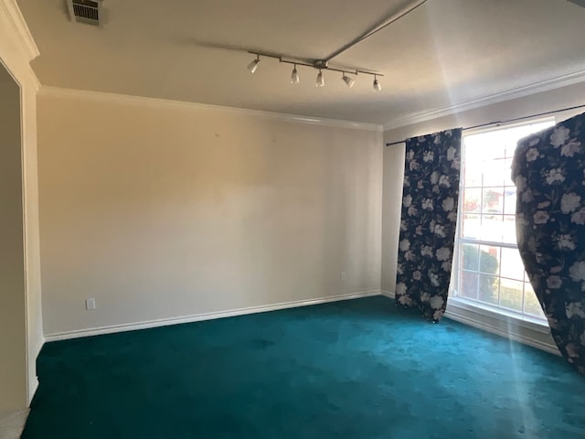 carpeted spare room with crown molding and track lighting