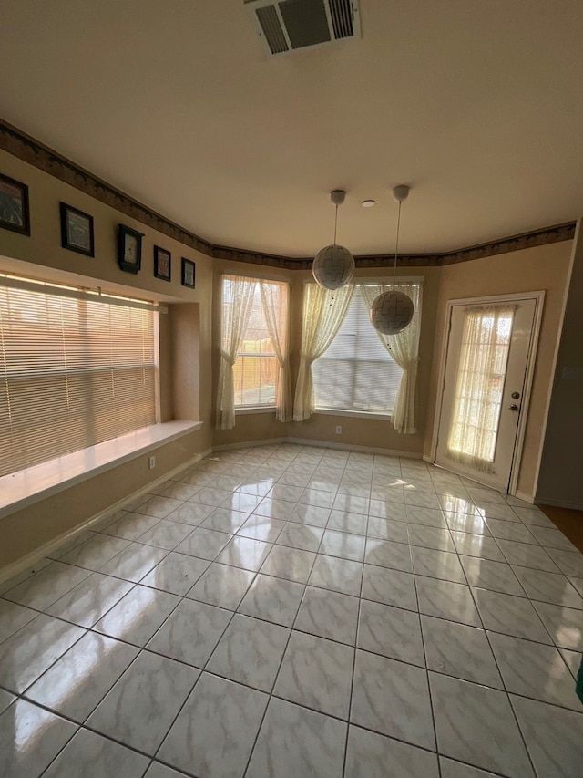 unfurnished dining area featuring light tile patterned floors and a wealth of natural light