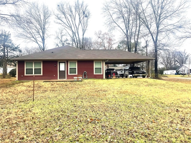 back of house with a yard and a carport