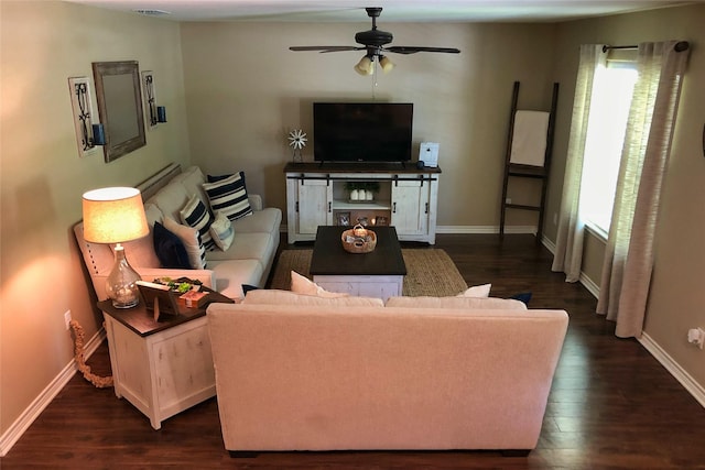 living room with dark wood-type flooring and ceiling fan