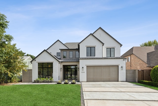 view of front of house with a garage and a front yard