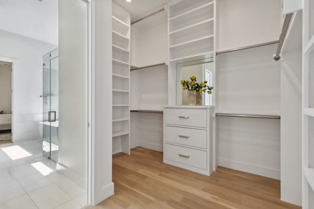 spacious closet featuring light hardwood / wood-style flooring