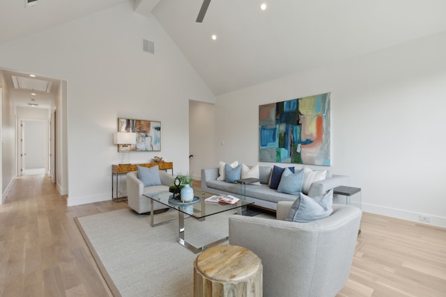 living room featuring beam ceiling, ceiling fan, high vaulted ceiling, and light wood-type flooring