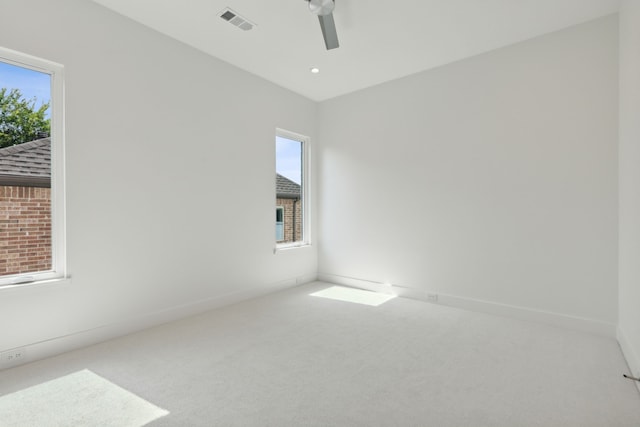 carpeted empty room featuring ceiling fan