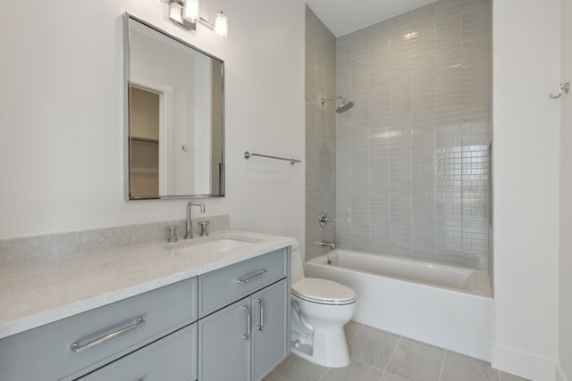 full bathroom featuring tile patterned flooring, vanity, toilet, and tiled shower / bath