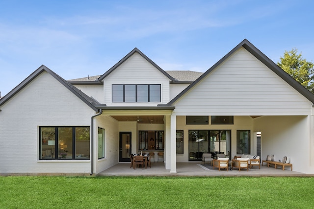 back of house featuring an outdoor hangout area, a lawn, and a patio area