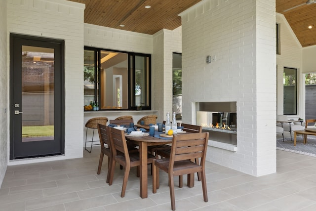 view of patio / terrace with an outdoor brick fireplace