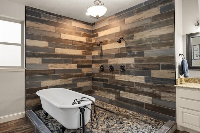 bathroom with independent shower and bath, vanity, hardwood / wood-style floors, and wooden walls