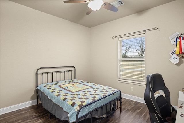 bedroom with ceiling fan and dark hardwood / wood-style flooring