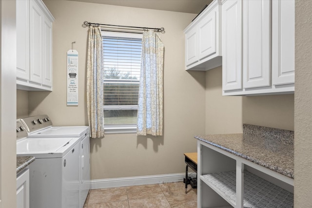 laundry area featuring cabinets, separate washer and dryer, and light tile patterned floors