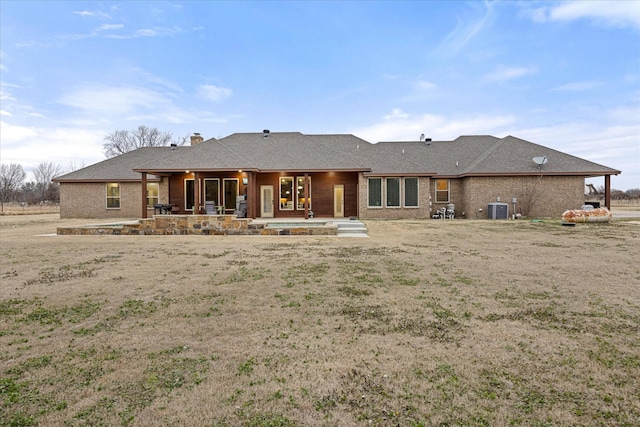 rear view of house featuring cooling unit and a patio area