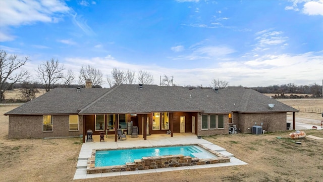 rear view of property with a patio area and central air condition unit