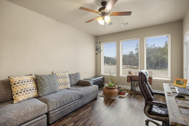 office space with dark wood-type flooring, ceiling fan, and a healthy amount of sunlight