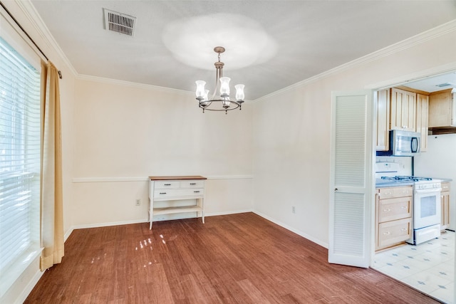 unfurnished dining area with crown molding, an inviting chandelier, and light hardwood / wood-style floors