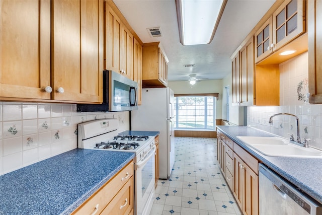 kitchen with ceiling fan, sink, backsplash, and white appliances