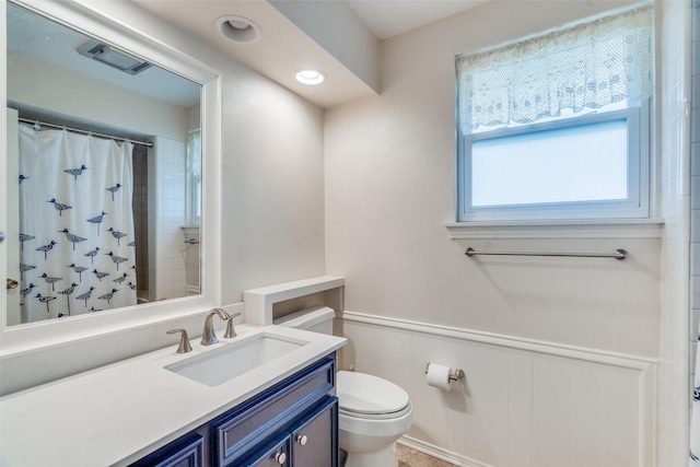 bathroom featuring vanity, toilet, and a shower with shower curtain