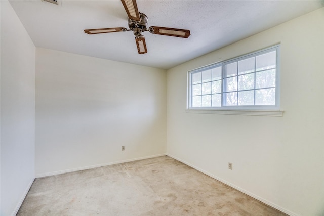 unfurnished room featuring ceiling fan and light carpet