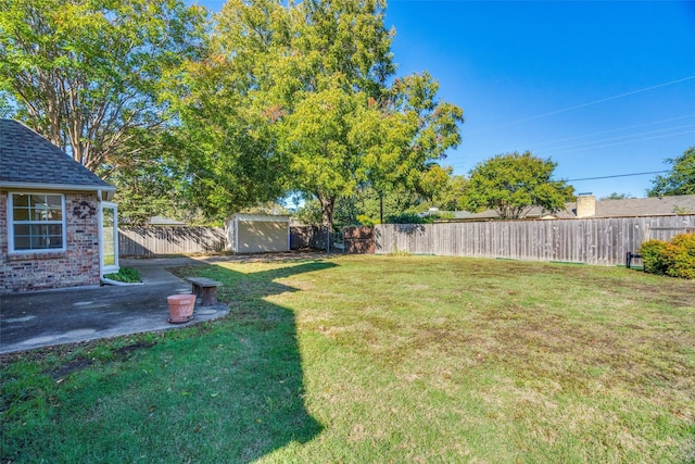 view of yard featuring a shed and a patio