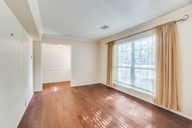 spare room with crown molding and hardwood / wood-style floors