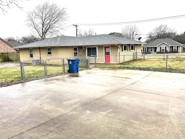 ranch-style house featuring central AC unit and a front lawn