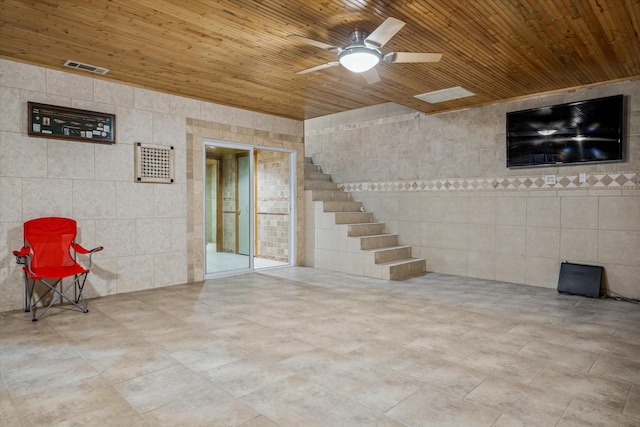 basement with ceiling fan and wood ceiling