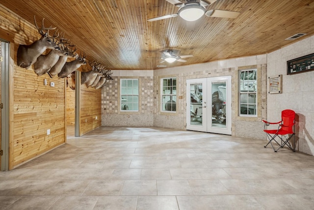 interior space featuring french doors, visible vents, wooden ceiling, and a ceiling fan