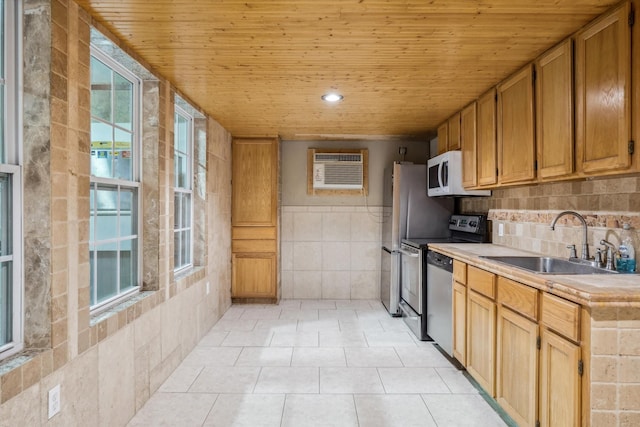 kitchen featuring a sink, stove, light countertops, white microwave, and wood ceiling