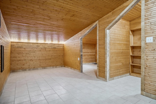 bonus room featuring tile patterned floors, wooden walls, wooden ceiling, and lofted ceiling