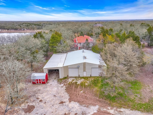 birds eye view of property with a forest view and a water view