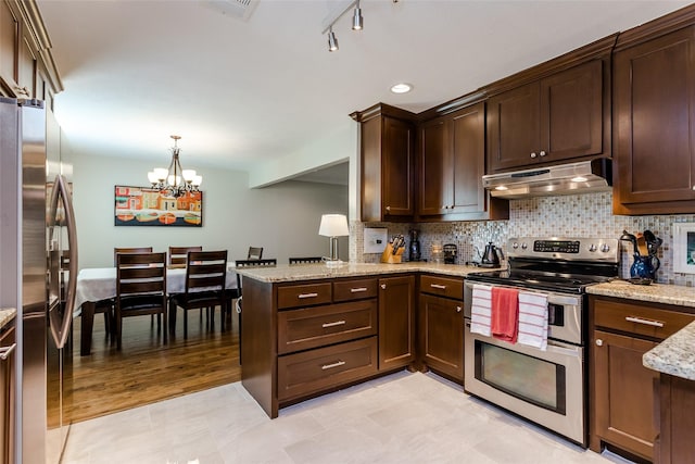 kitchen with stainless steel appliances, light stone countertops, decorative backsplash, decorative light fixtures, and kitchen peninsula