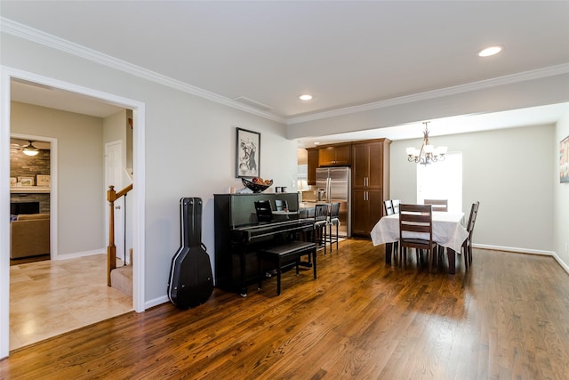 dining area featuring crown molding, dark hardwood / wood-style flooring, and an inviting chandelier